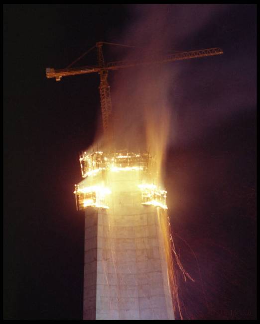 A construction crane rises above the fire that engulfed the upper limits of ongoing growth of t ...