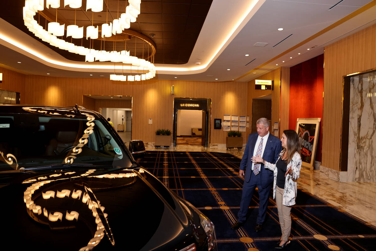 CEO Derek Stevens and Director of Sales Sasha Lee with a Cadillac Escalade in the pre-function ...
