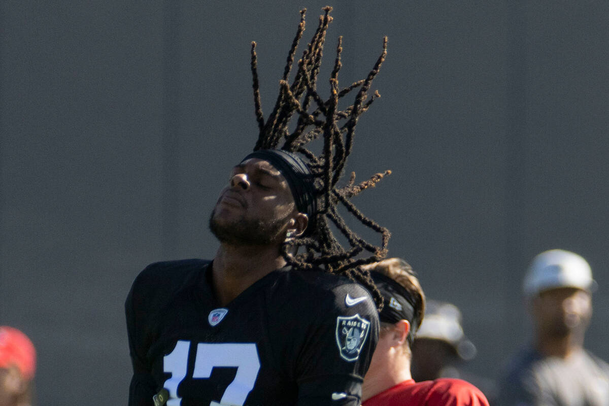 Raiders wide receiver Davante Adams (17) flips his hair back during the team’s training ...