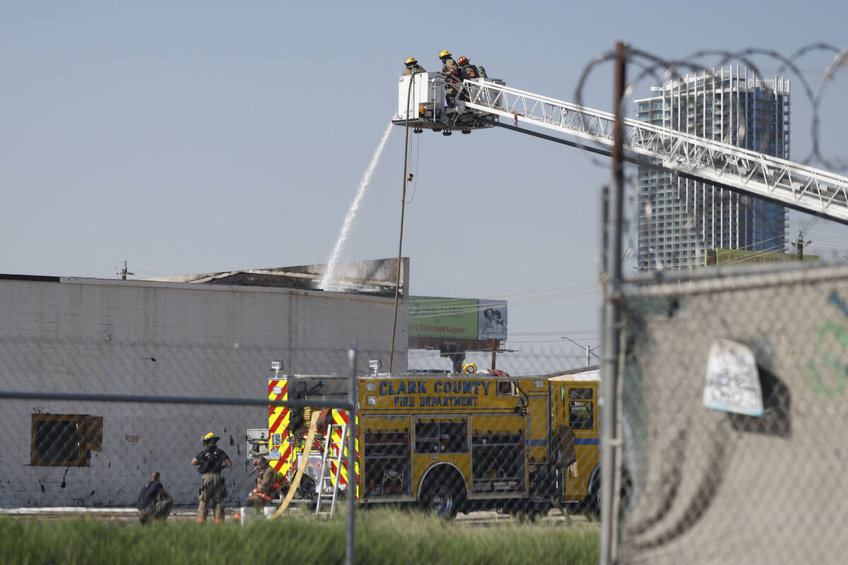 Firefighters try to extinguish a fire near Procyon Street, Tuesday, Aug. 23, 2022, in Las Vegas ...