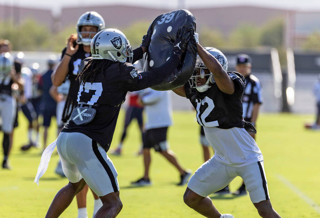 Raiders wide receiver Davante Adams (17) works against wide receiver Justin Hall (12) during th ...