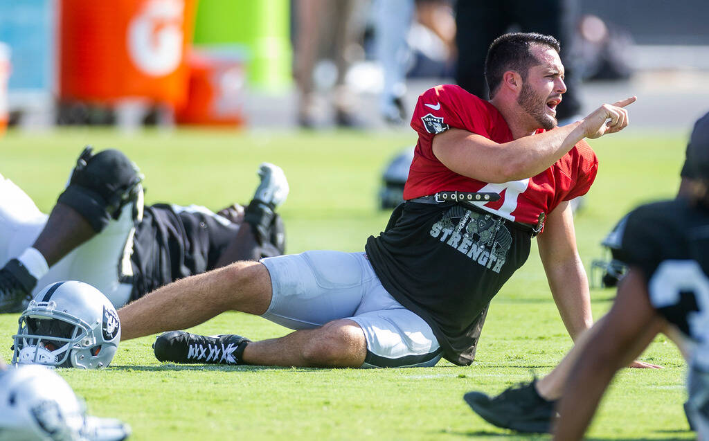Raiders quarterback Derek Carr (4) talks while stretching during practice at the Intermountain ...