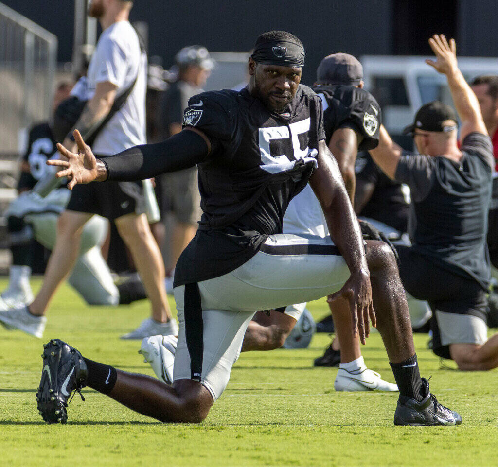 Raiders defensive end Chandler Jones (55) stretches during the team’s training camp prac ...