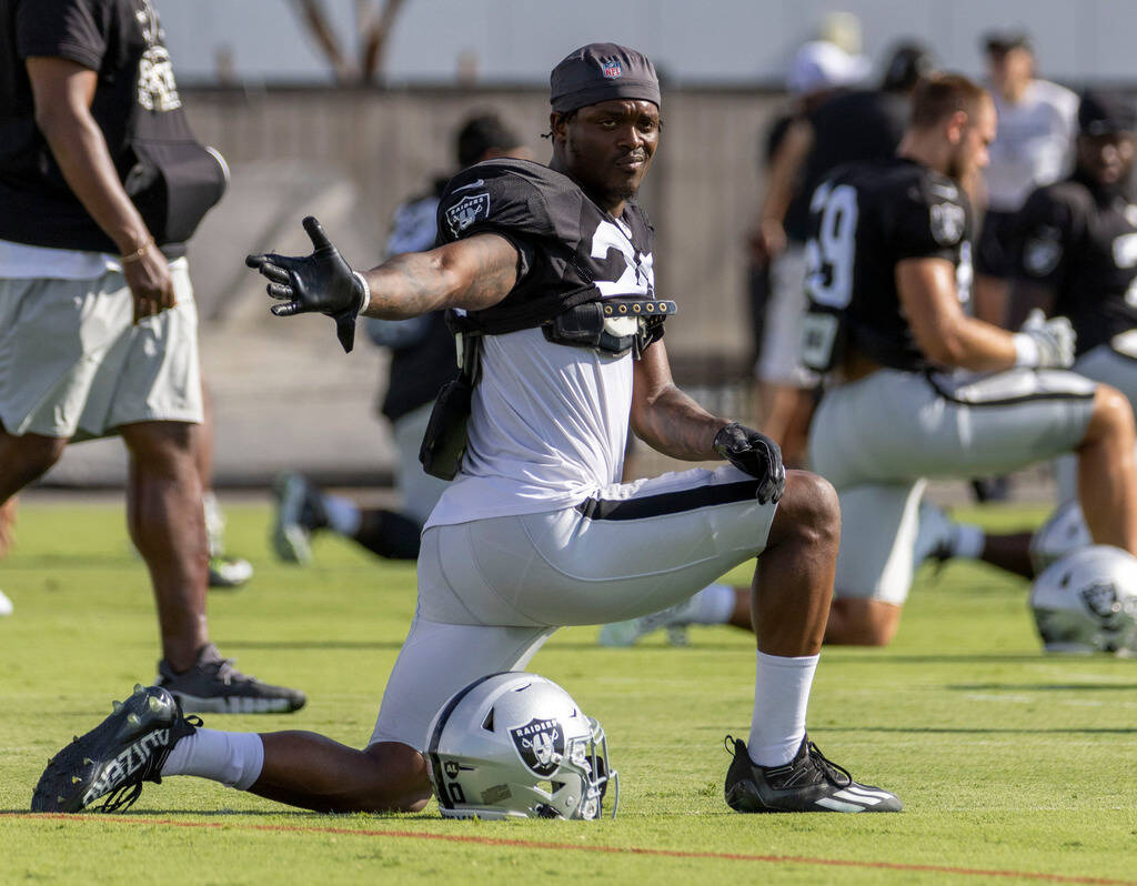 Raiders cornerback Darius Phillips (20) stretches during the team’s training camp practi ...
