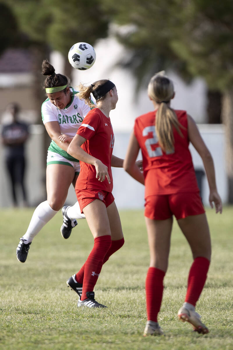 Green Valley’s Sofia Grant (20) heads the ball next to Arbor View’s Madison Littl ...