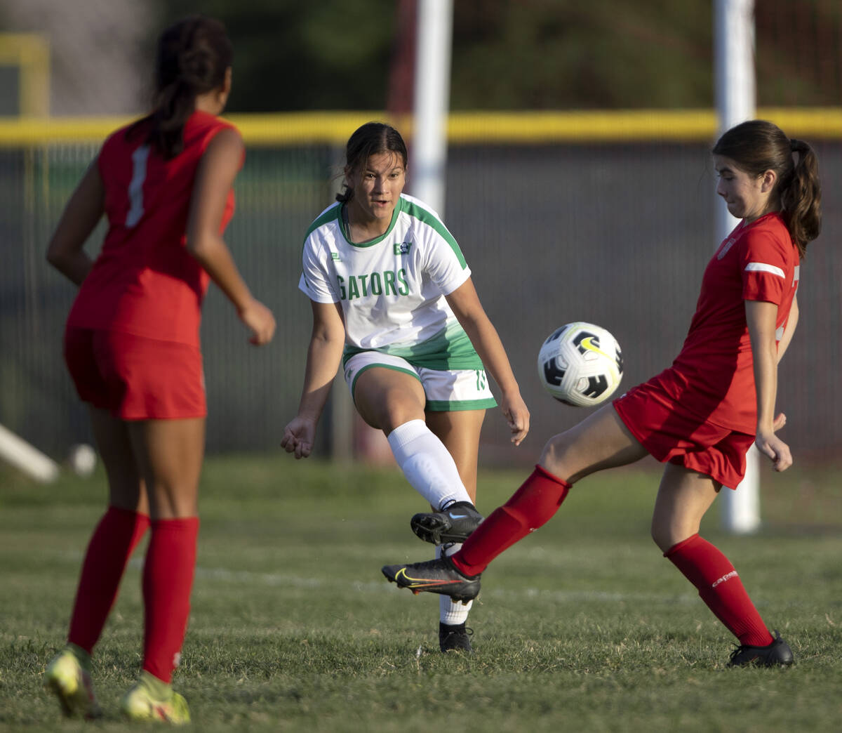 Green Valley’s Sienna Grandstaff (13) passes in between Arbor View’s Jazlyn Chave ...