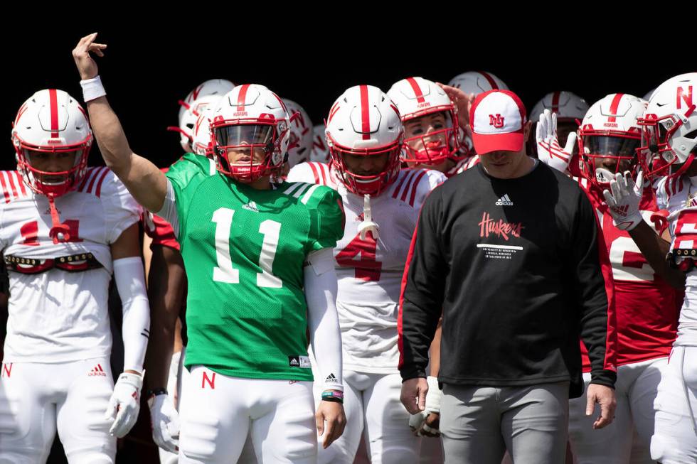 Nebraska quarterback Casey Thompson (11) and coach Scott Frost, right, are shown Saturday, Apri ...