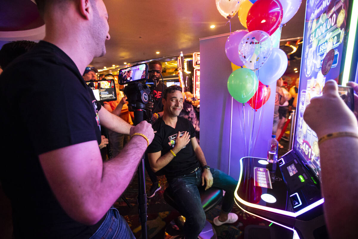 YouTuber Brian Christopher, left, livestreams as his husband, Marco, plays on the new slot mach ...