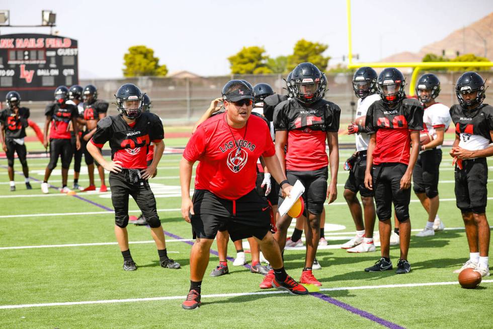 Head coach Erick Capetillo addresses players during football practice at Las Vegas High School ...