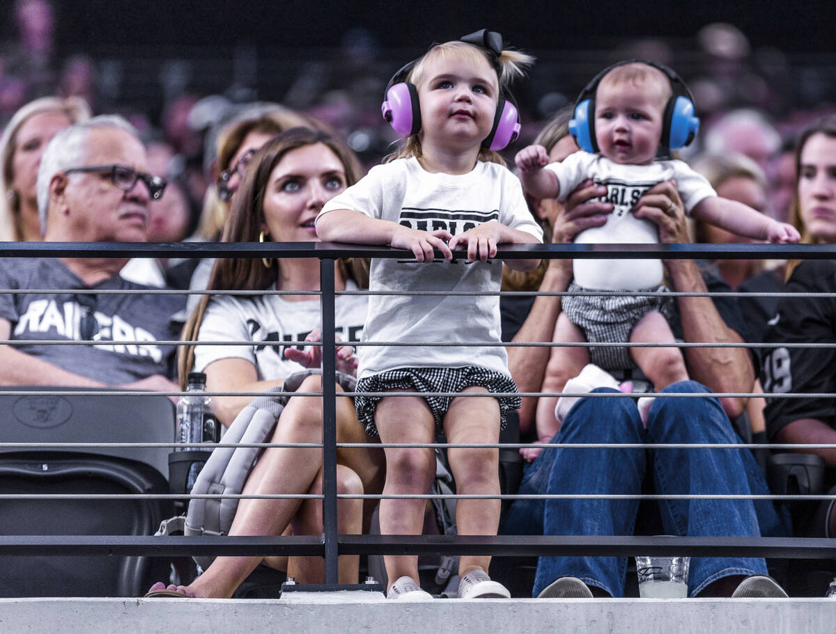 Young fans and possibly family members of Raiders place kicker Daniel Carlson (2) fans wear t-s ...