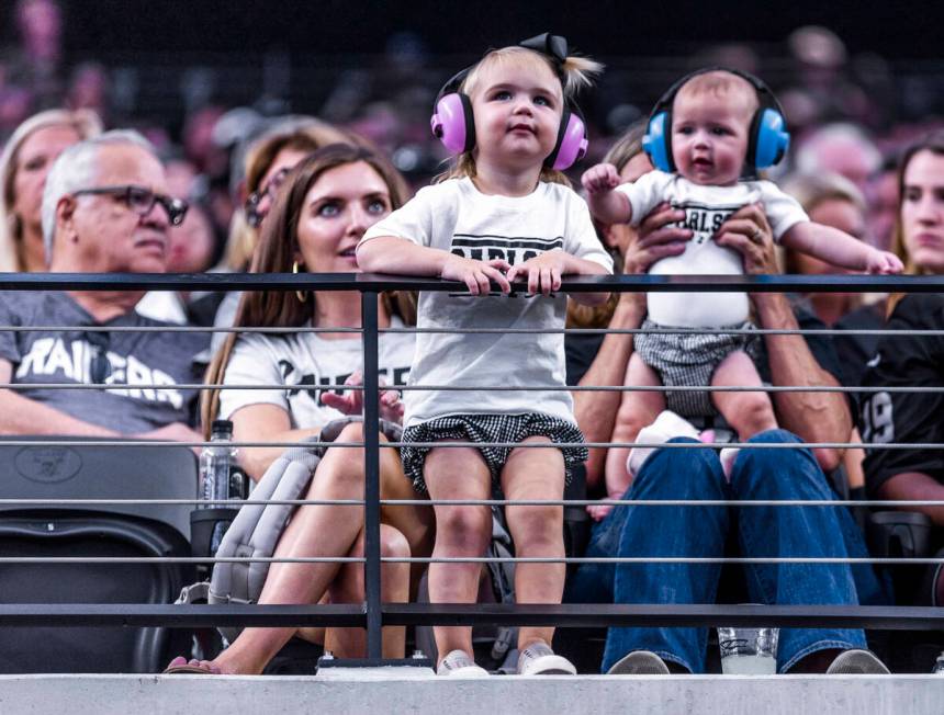 Young fans and possibly family members of Raiders place kicker Daniel Carlson (2) fans wear t-s ...