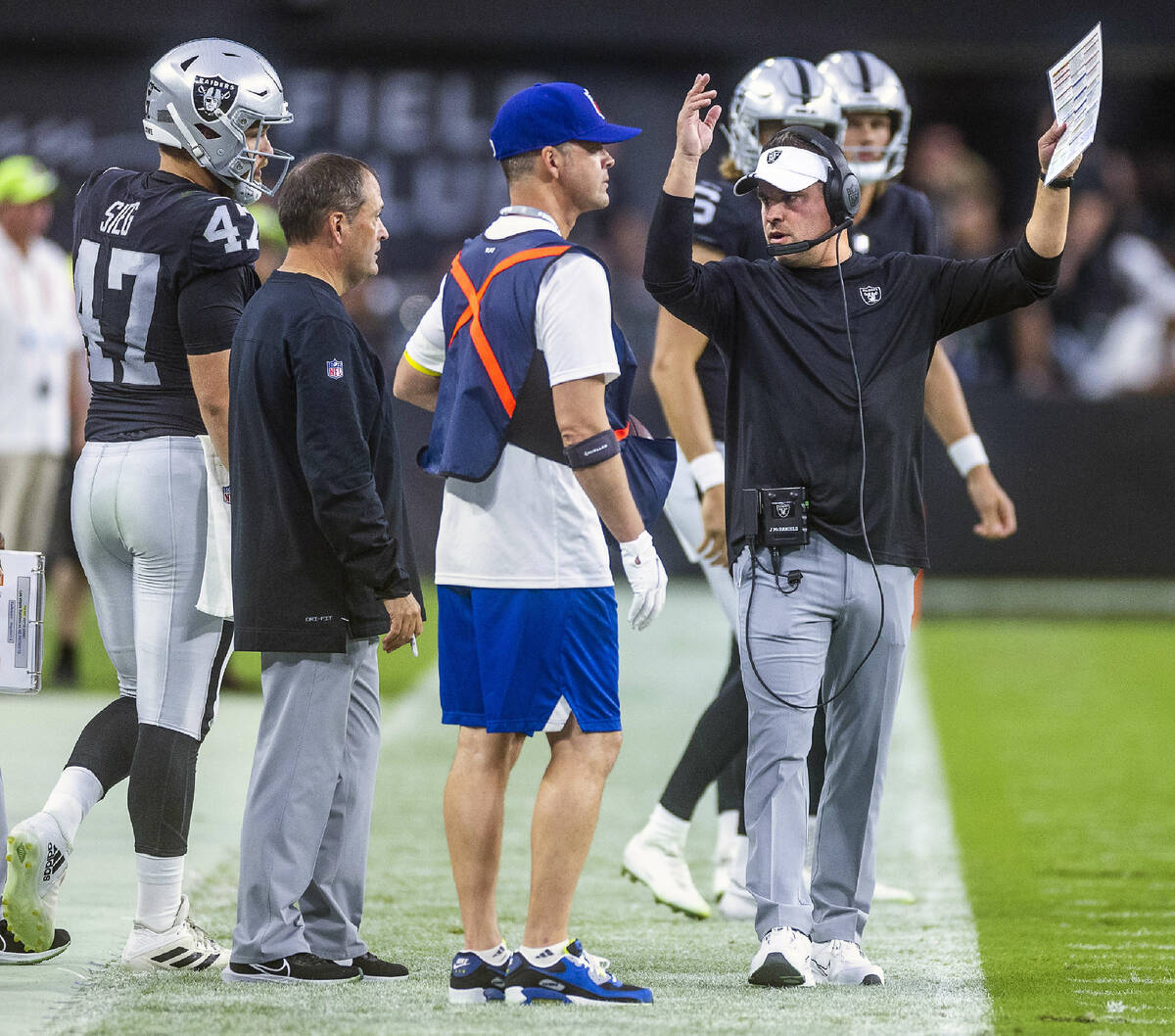 Raiders head coach Josh McDaniels is unhappy with a player on the sidelines versus the Patriots ...