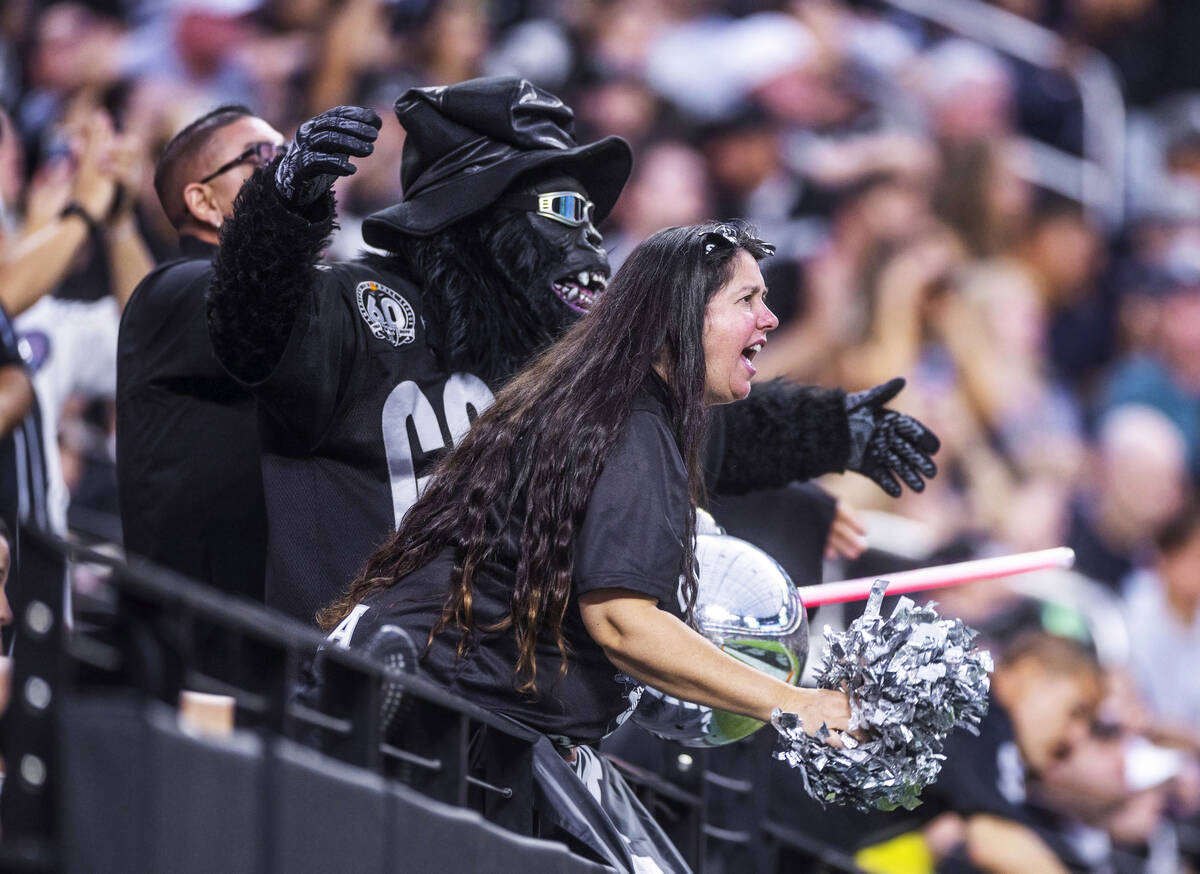 Raiders fans cheer on their team versus the Patriots during the first half of their NFL preseas ...