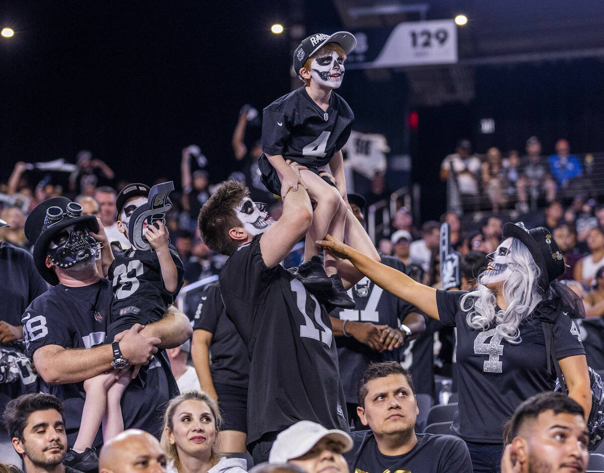 Raiders fans celebrate another win, this versus the New England Patriots during the second half ...
