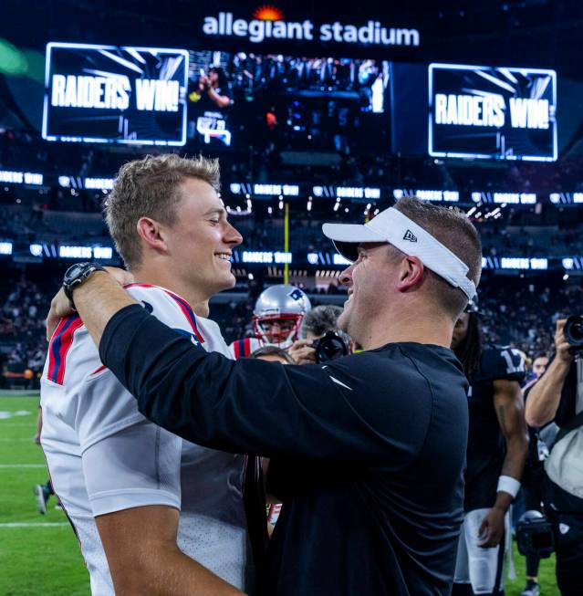 New England Patriots quarterback Mac Jones (10) greets Raiders Head Coach Josh McDaniels on the ...