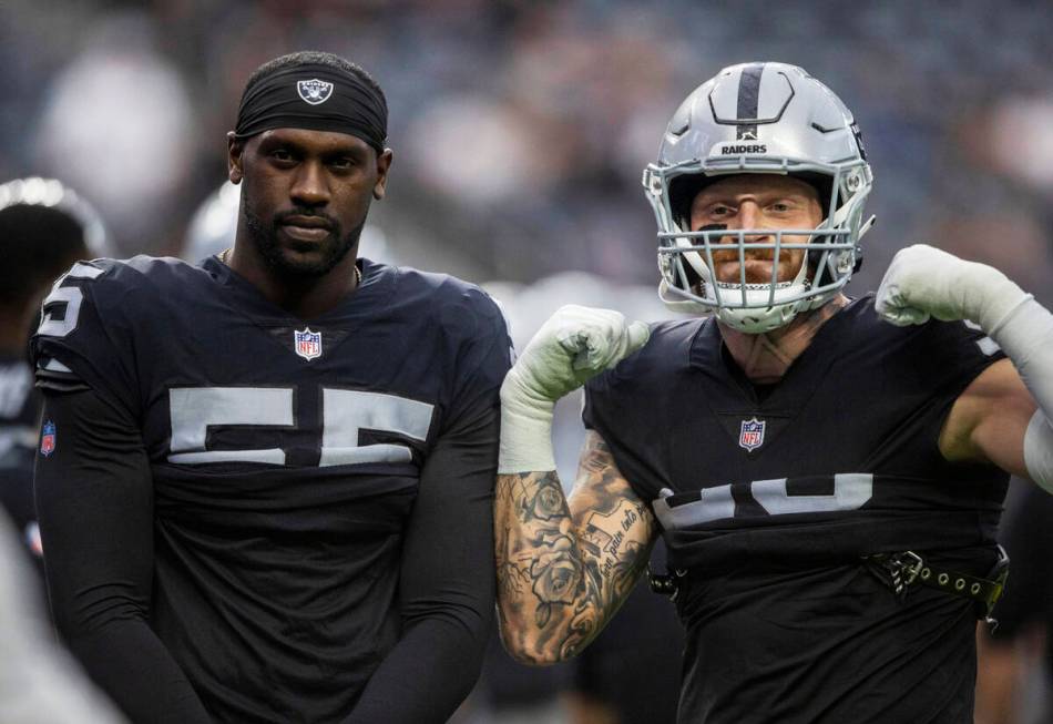 Raiders defensive ends Chandler Jones (55) and Maxx Crosby (98) pose before an NFL game against ...