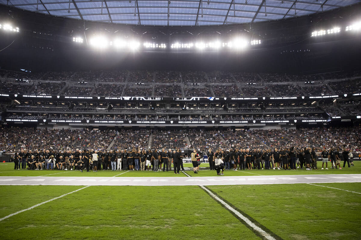 Raiders alumni are honored during halftime of a NFL preseason football game between the Raiders ...