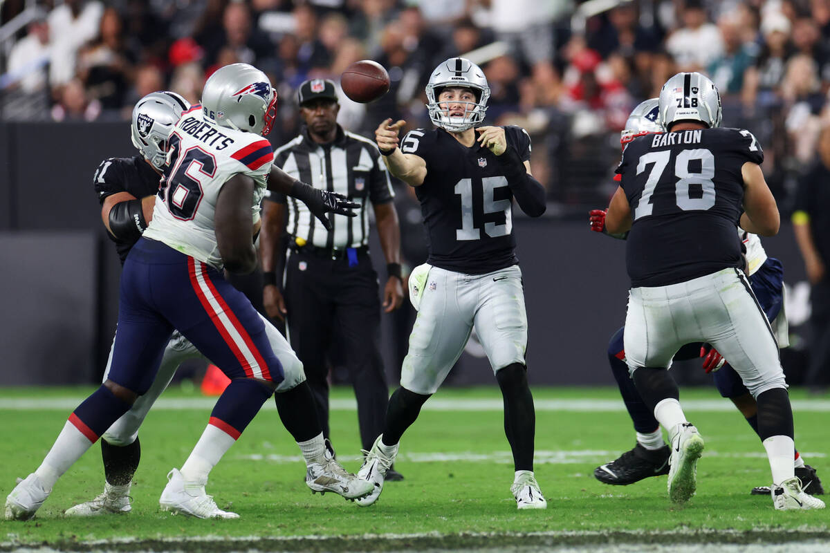 Raiders quarterback Chase Garbers (15) throws a pass against the New England Patriots during th ...