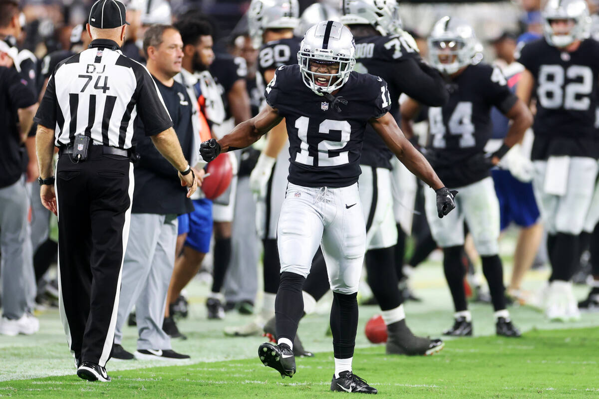 Raiders wide receiver Justin Hall (12) reacts after running back a punt during the second half ...