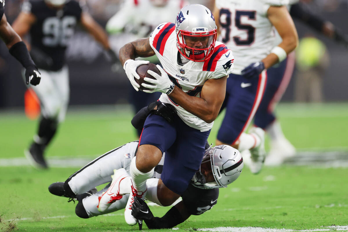 New England Patriots wide receiver Kendrick Bourne (84) is tackled by Raiders cornerback Isiah ...