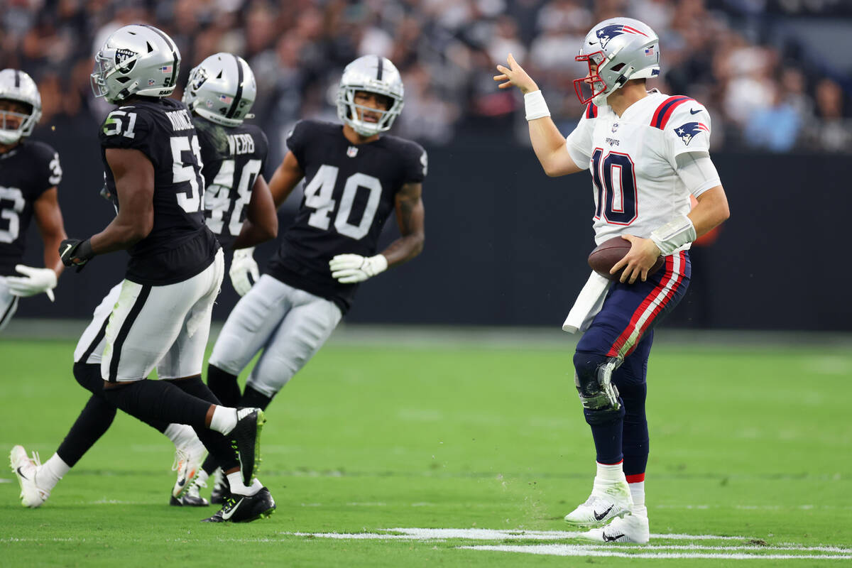 New England Patriots quarterback Mac Jones (10) gestures after running the ball against the Rai ...