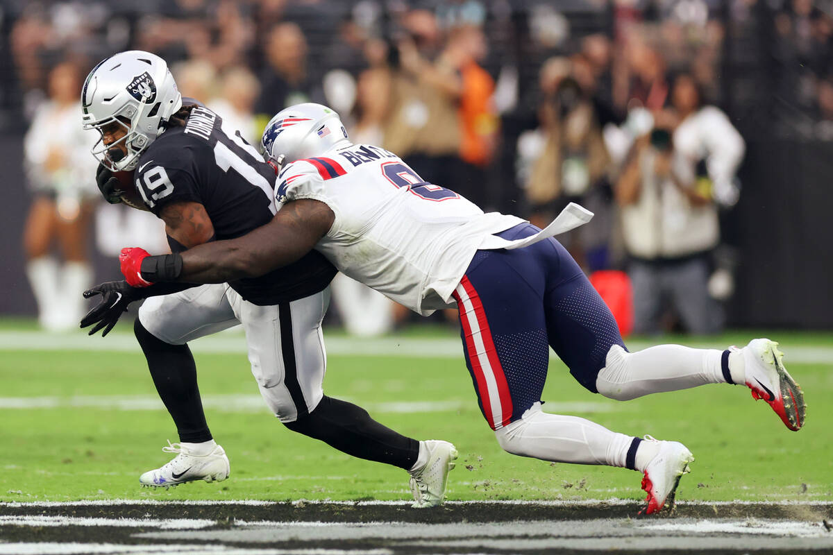 New England Patriots linebacker Ja'Whaun Bentley (8) tackled Raiders wide receiver DJ Turner (1 ...