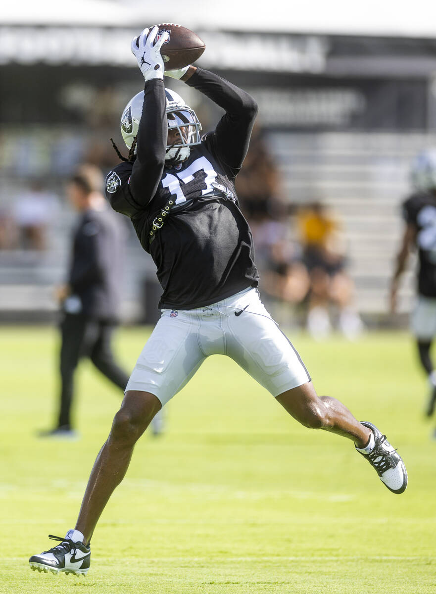 Raiders wide receiver Davante Adams (17) reaches for a pass reception during practice at the In ...