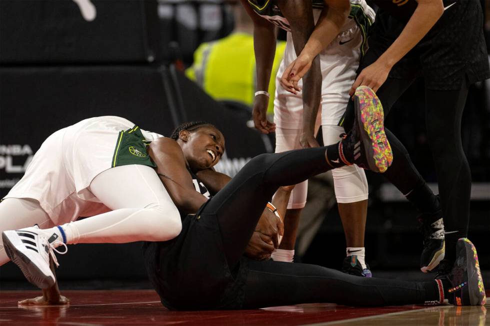 Las Vegas Aces guard Chelsea Gray, right, wrestles for the ball with Seattle Storm center Tina ...