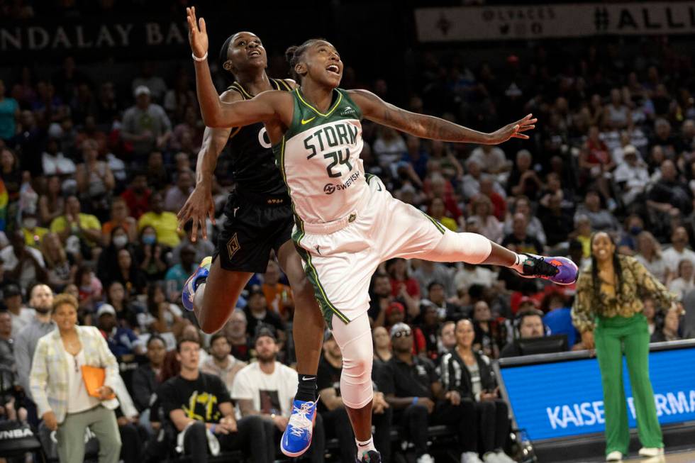 Las Vegas Aces guard Jackie Young (0) fouls Seattle Storm guard Jewell Loyd (24) while jumping ...