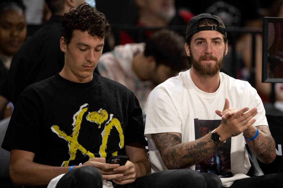 Vegas Golden Knights goaltender Logan Thompson, left, claps for the Las Vegas Aces during the s ...