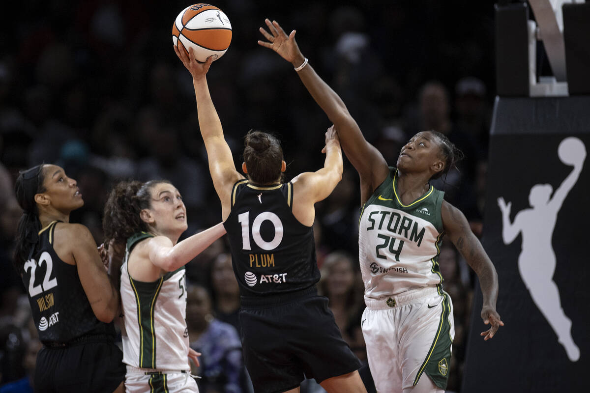 Seattle Storm guard Jewell Loyd (24) attempts to thwart a shot by Las Vegas Aces guard Kelsey P ...