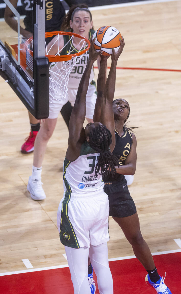 Seattle Storm center Tina Charles (31) grabs the ball from Las Vegas Aces guard Jackie Young (0 ...