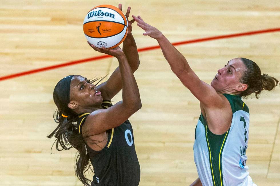 Las Vegas Aces guard Jackie Young (0) elevates to take a shot over Seattle Storm forward Stepha ...