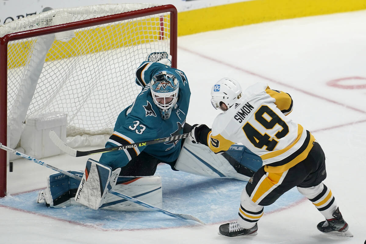 San Jose Sharks goaltender Adin Hill (33) defends a shot against Pittsburgh Penguins center Dom ...