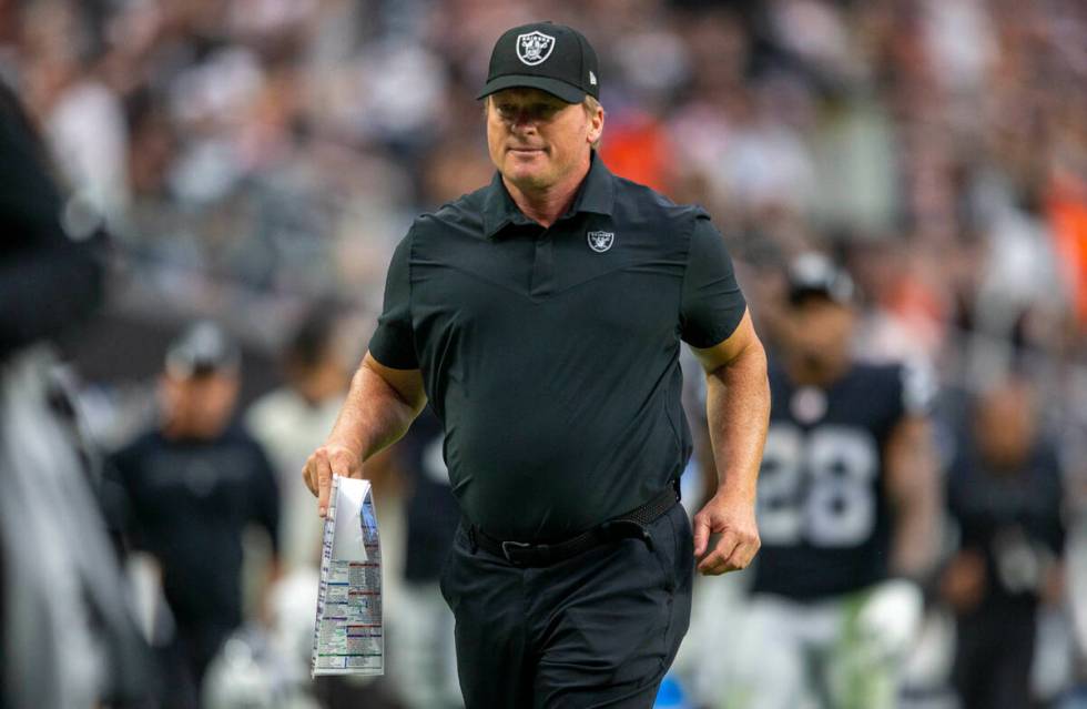 Raiders head coach Jon Gruden runs off the field for halftime during an NFL football game again ...