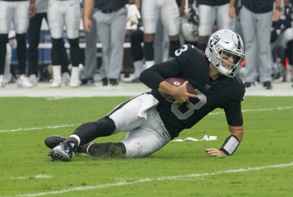 Raiders quarterback Jarrett Stidham (3) slides after a run during the first half of a preseason ...