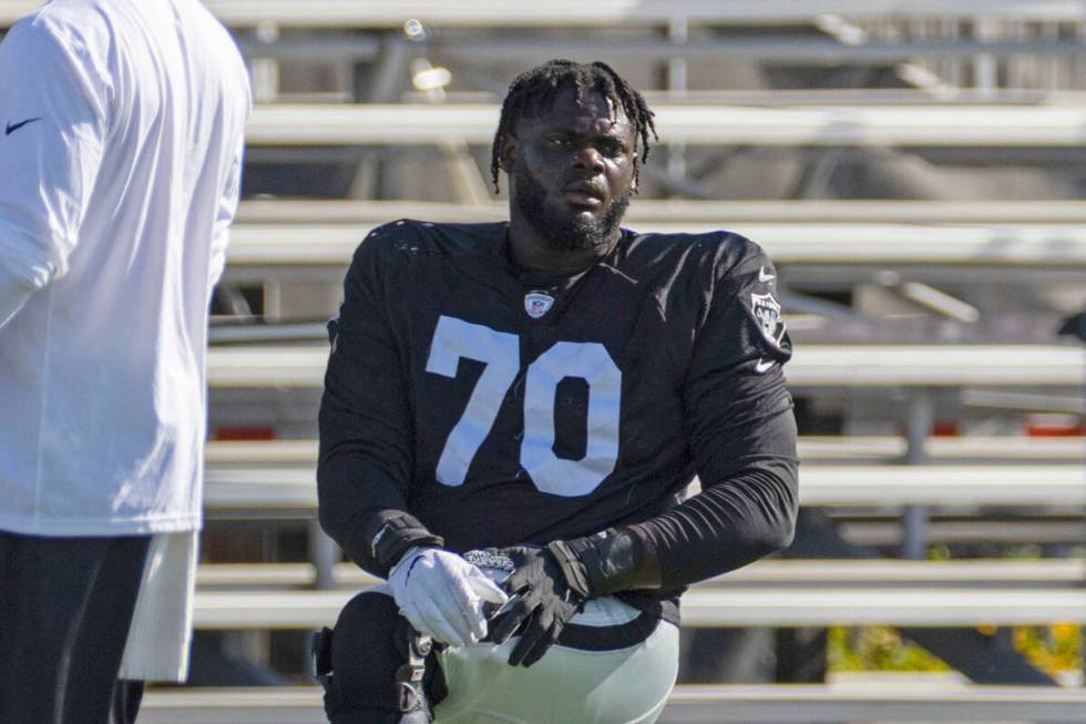 Raiders offensive tackle Alex Leatherwood (70) stretches during the team’s training camp ...