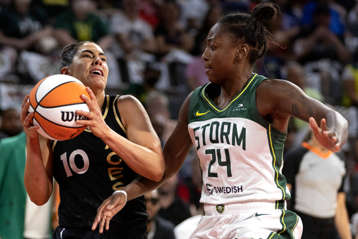 Las Vegas Aces guard Kelsey Plum (10) drives around Seattle Storm guard Jewell Loyd (24) during ...