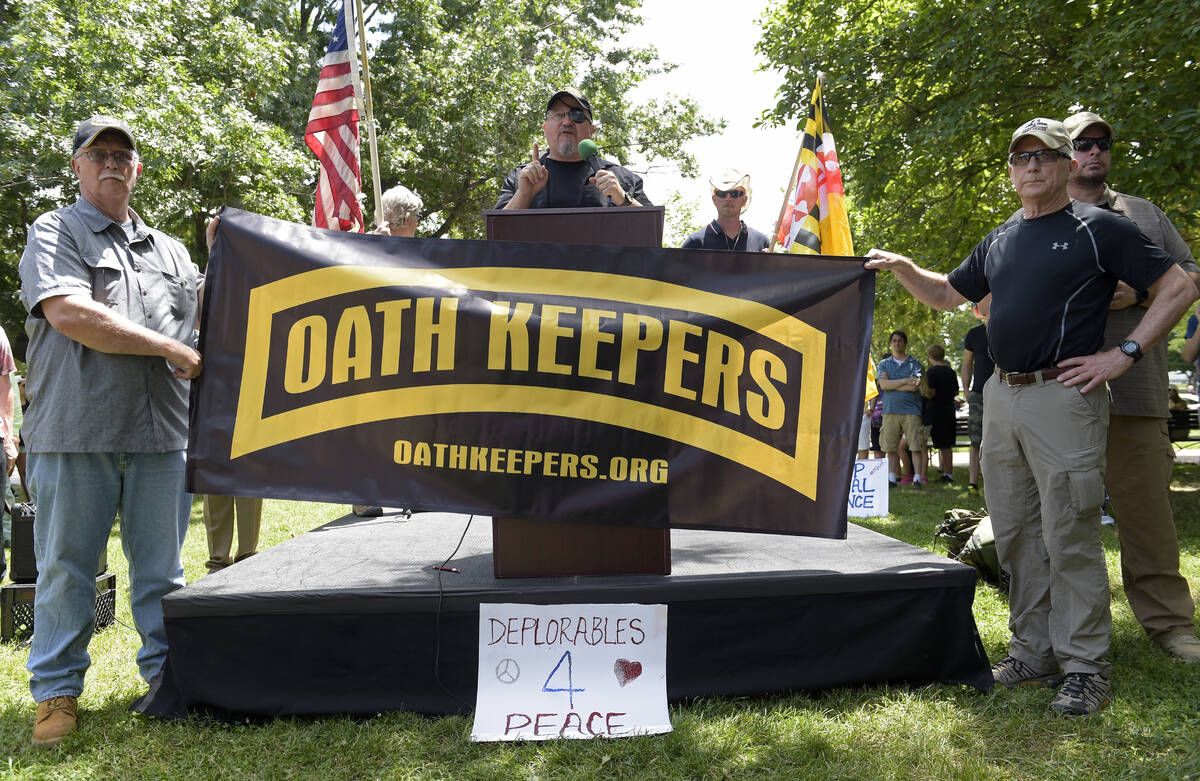 Stewart Rhodes, founder of the citizen militia group known as the Oath Keepers, center, speaks ...