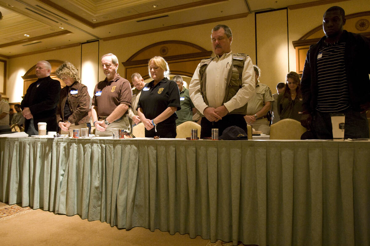 Oath Keepers members and guests bow their heads during the invocation at the Oath Keepers inaug ...