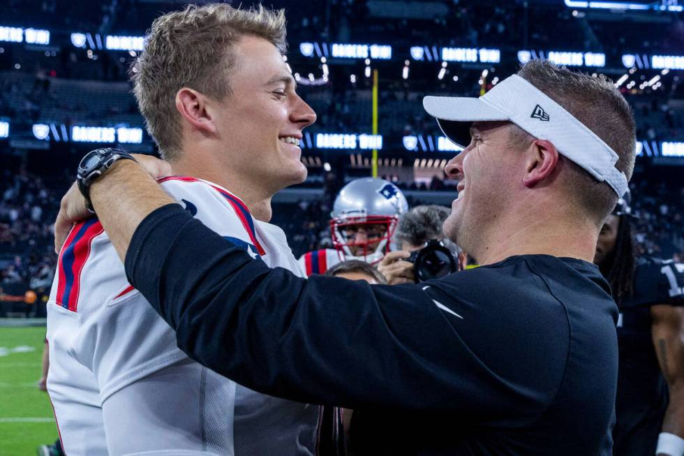 New England Patriots quarterback Mac Jones (10) greets Raiders Head Coach Josh McDaniels on the ...