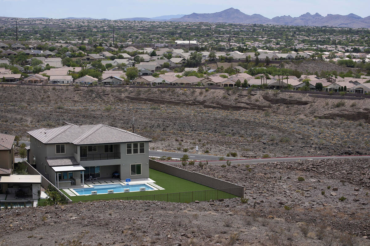 A home with a swimming pool abuts the desert on the edge of the Las Vegas valley, Wednesday, Ju ...