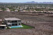 A home with a swimming pool abuts the desert on the edge of the Las Vegas valley, Wednesday, Ju ...
