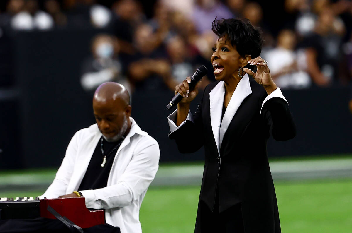 Gladys Knight sings the national anthem before an NFL football game between the Raiders and the ...