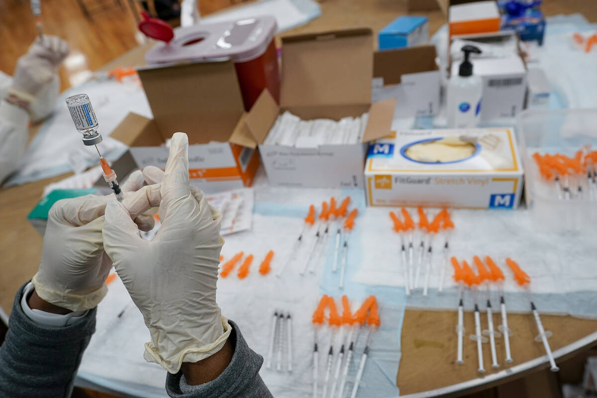 FILE - In this April 8, 2021, file photo, a Northwell Health registered nurses fills a syringe ...
