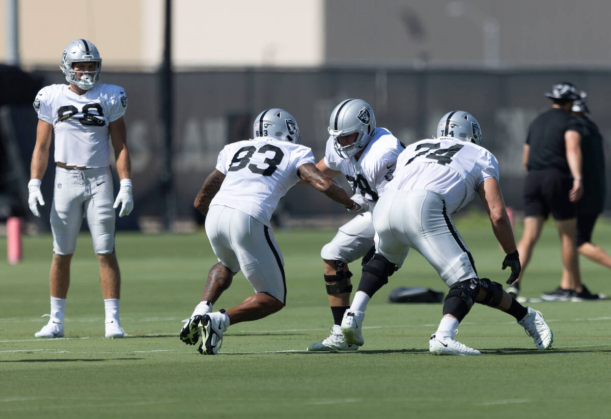 Raiders tight end Darren Waller (83) attacks offensive tackle Jackson Barton (78) as offensive ...