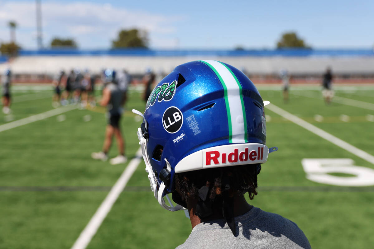 A player wears a helmet with a decal in honor of late strength and conditioning coach Loymon Ju ...
