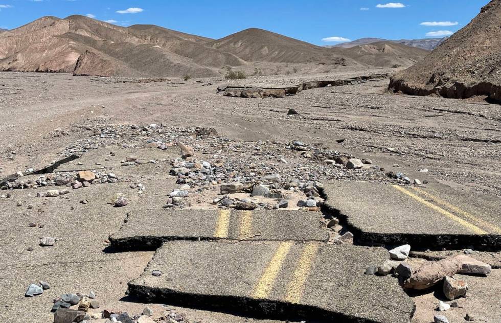 Sections of asphalt pavement litter the path of still closed Mud Canyon Road at Death Valley Na ...