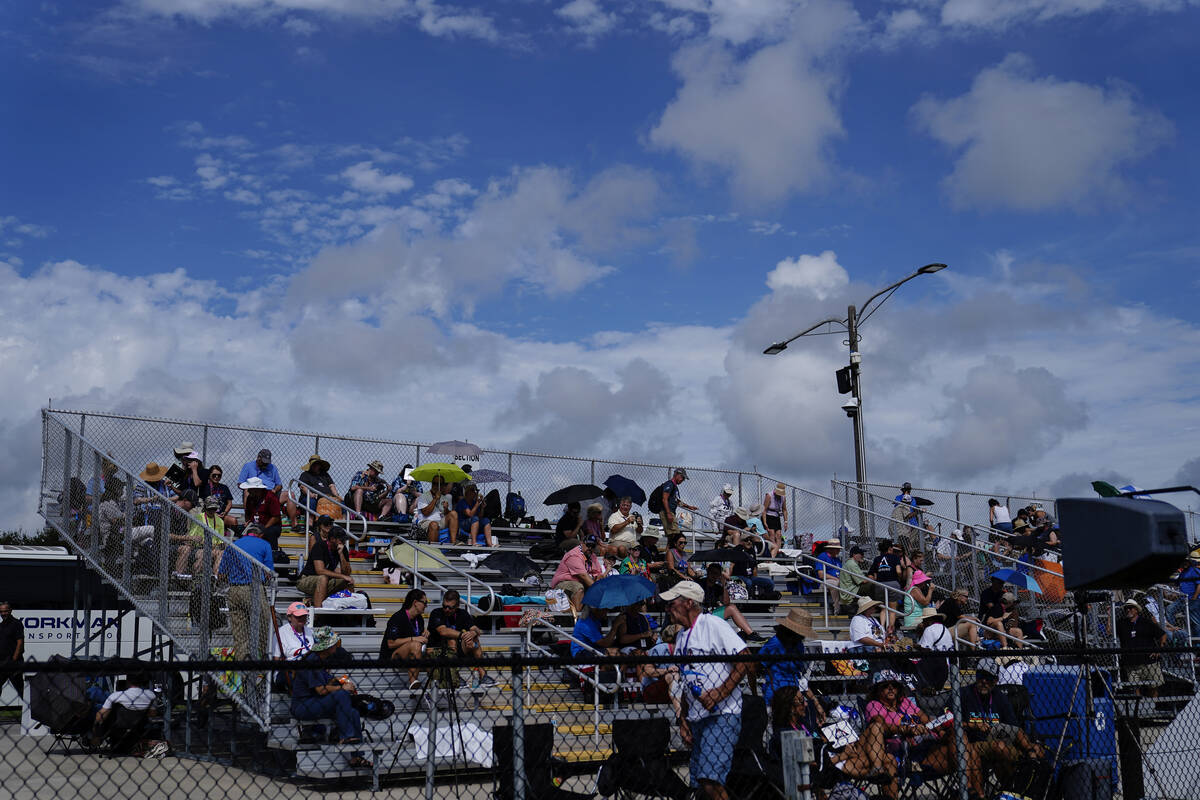 People wait for the NASA moon rocket to launch on Pad 39B before the Artemis 1 mission to orbit ...