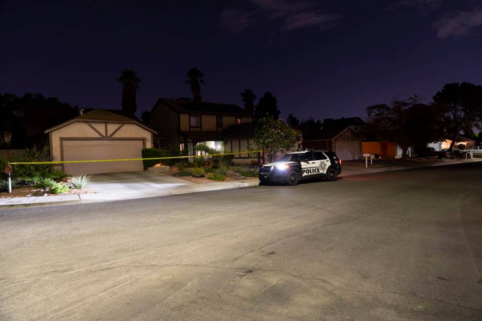 Las Vegas police monitor a homicide scene at the 7200 block of Bronze Circle in Las Vegas, Satu ...